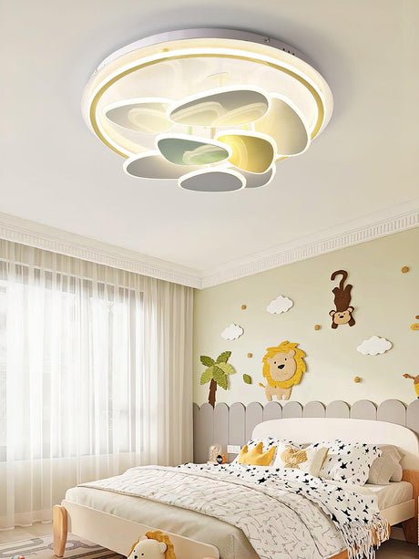 Cloud motif ceiling light above a child bed with animal wall stickers