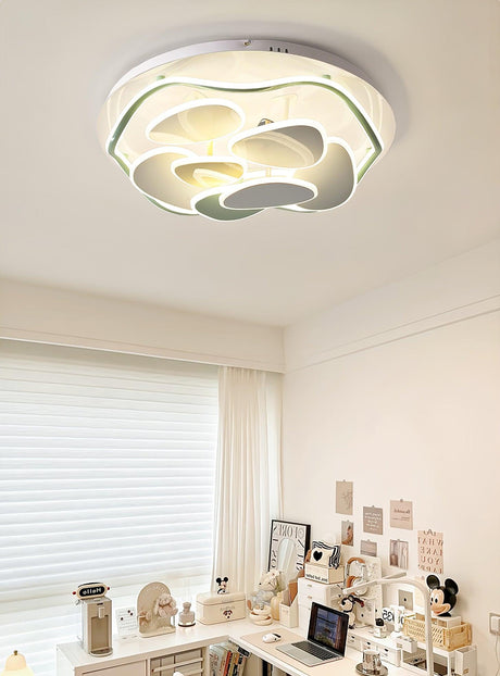 Cloud motif ceiling light lit in a room with a desk and a window