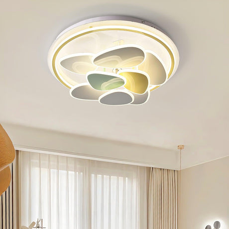 Cloud motif ceiling light in a bedroom with long curtains and a bed