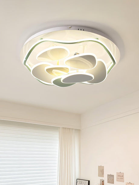 Cloud motif ceiling light lit above a desk in a pale child bedroom