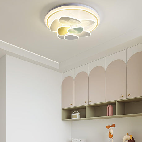 Cloud motif ceiling light above a bed with arched wall cabinets