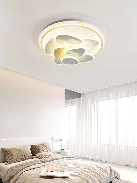 Cloud motif ceiling light lit in a bright bedroom with sheer curtains