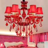 Red Crystal Chandelier Installed Above Dining Table
