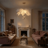 The fitting lit in the evening above pink sofas beside a marble fireplace
