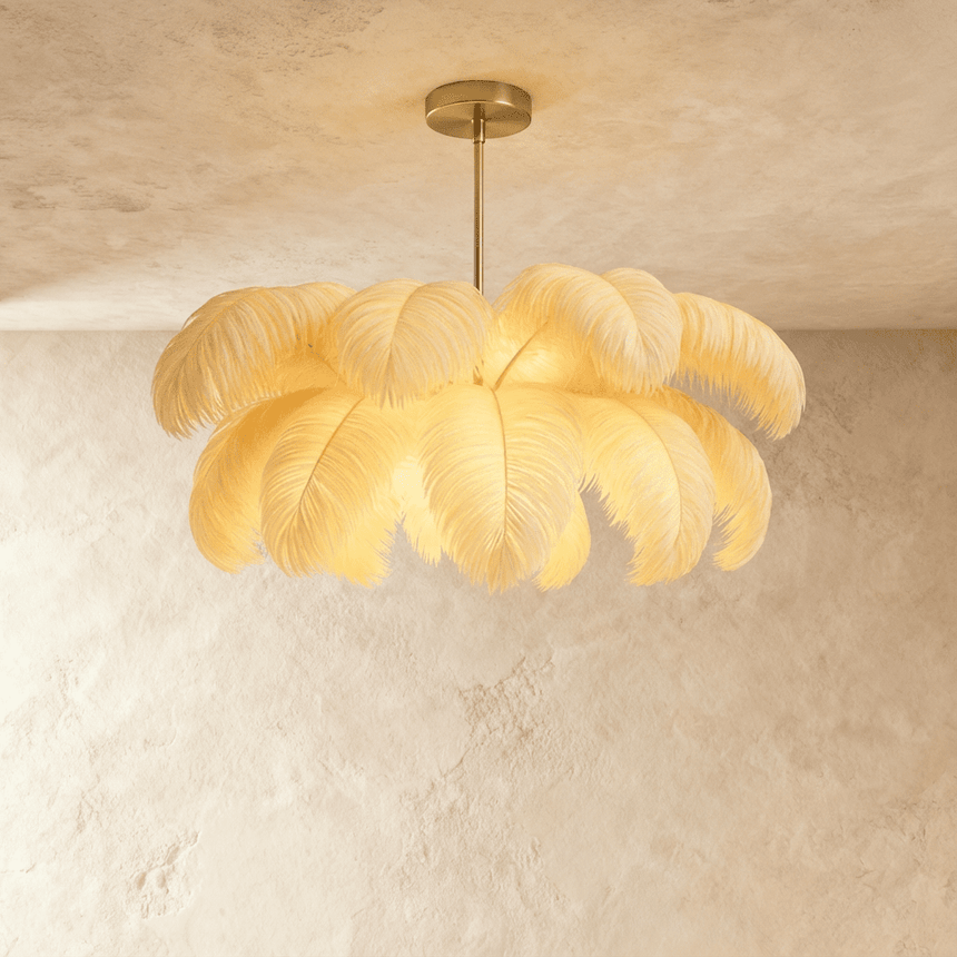 A dome of white ostrich feathers lit from within, hung from a slim gold stem