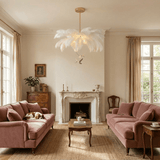 The fitting above two pink sofas facing a marble fireplace and a coffee table
