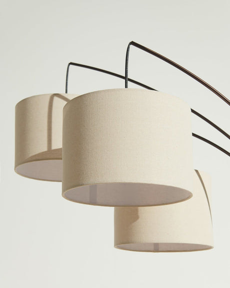 The three oatmeal drums seen close, each arm entering its own shade