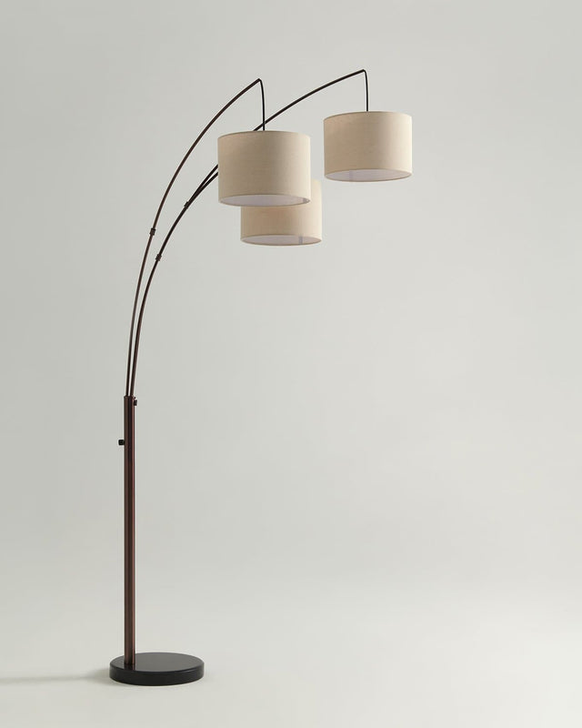 Bronze floor lamp with three curved arms carrying three linen drum shades