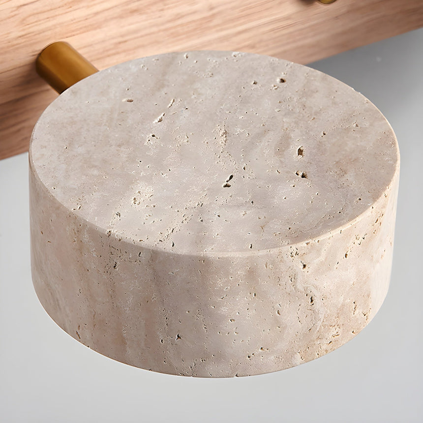 Close view of a bare travertine disc showing its open pores and pale banding
