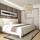 Hung in a bedroom above a made bed against a paneled wall with a framed print