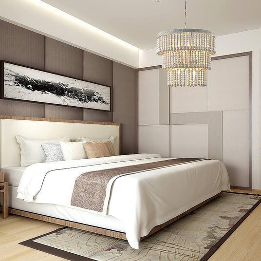 Hung in a bedroom above a made bed against a paneled wall with a framed print
