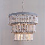The three tiers of bead strands against a plain gray wall, lamps lit inside