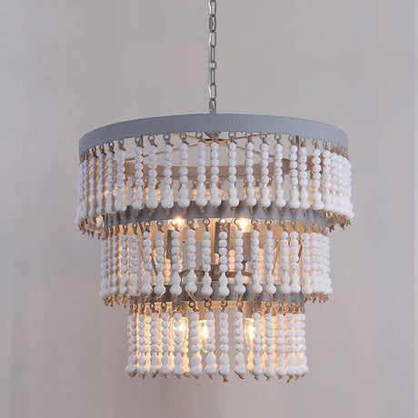 The three tiers of bead strands against a plain gray wall, lamps lit inside