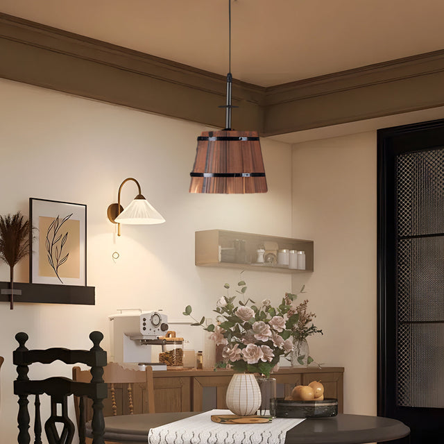 Metal pendant light with sculptural bucket silhouette