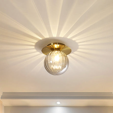 Gold glass LED ceiling light with sleek modern silhouette