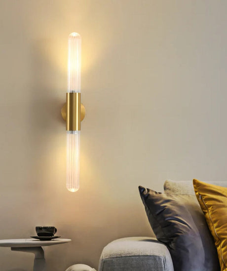 Wall lamp illuminated in bedroom setting