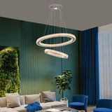 crystal chandelier lit in dining room setting