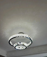 black ring chandelier lit in dining room