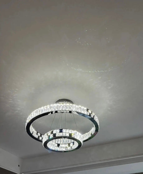 black ring chandelier lit in dining room