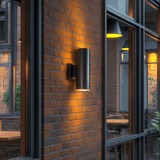 Wall light mounted beside a garden gate
