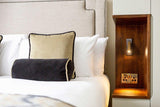 Unobtrusive wall sconce for compact bedrooms