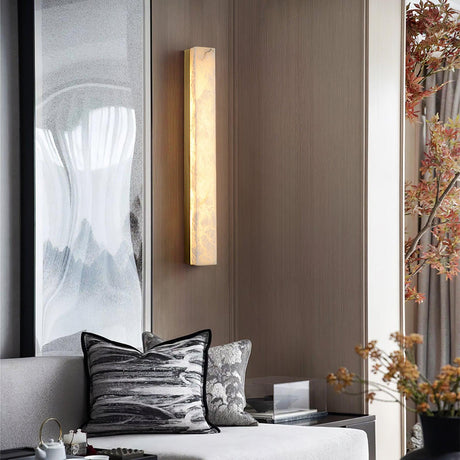 Lyra brass alabaster wall lamp warm glow lit view
