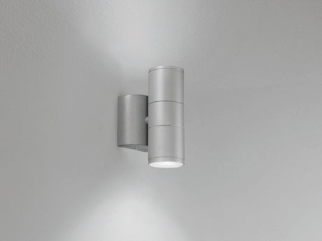 Twin head wall lamp shown at night
