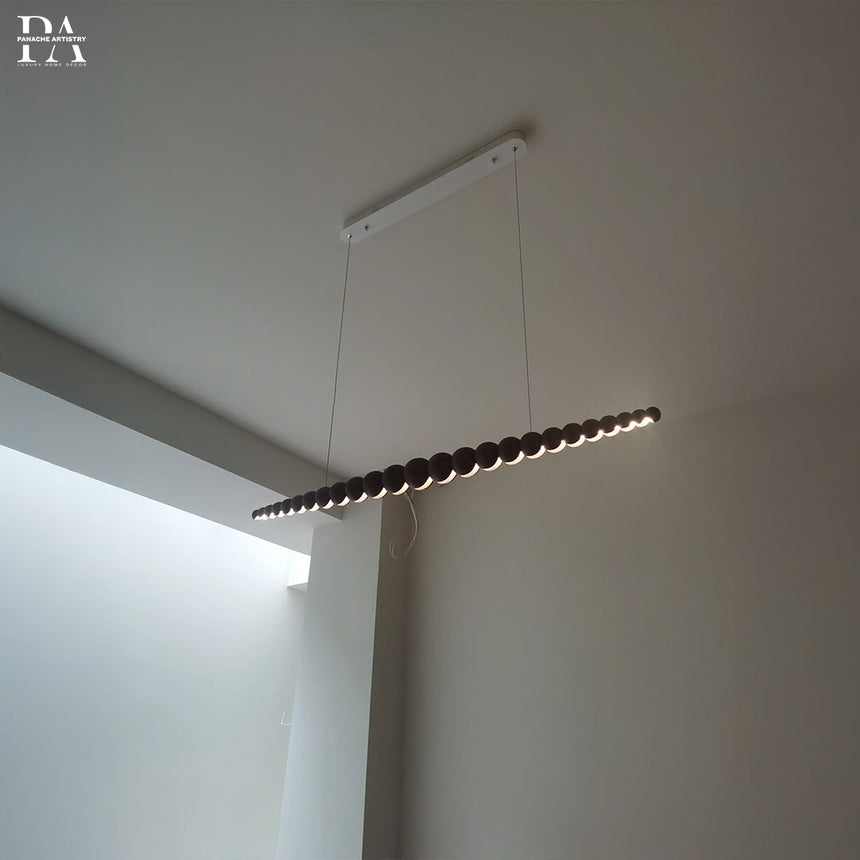 Varena linear pendant lamp wooden spheres close-up