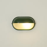 Oval outdoor wall lamp mounted on porch