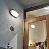 Outdoor wall lamp illuminated at dusk