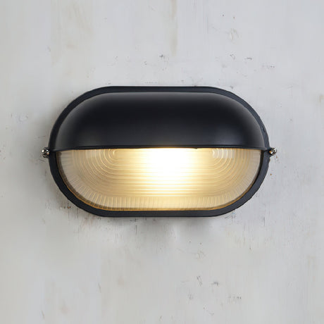 Wall lamp casting glow on exterior brick wall