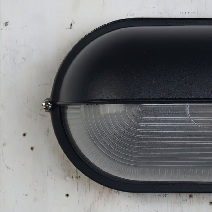 Oval glass wall light for patio evening ambiance