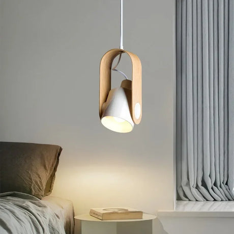 Metal pendant lamp illuminated above dining table