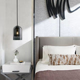Glass pendant light installed above dining table