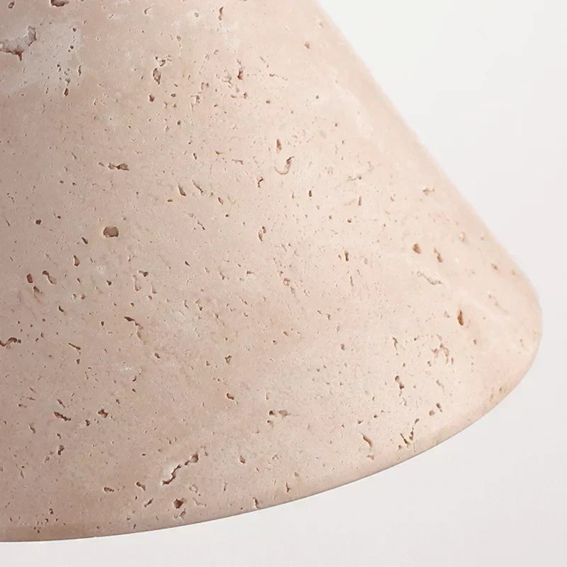 Perforated stone wall light fixture