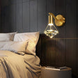 Wall sconce mounted above a nightstand