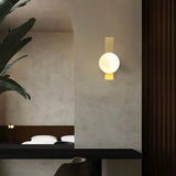 Glass stone wall lamp with gilded finish and warm LED glow