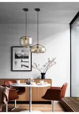 Glass pendant light installed above kitchen island