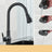 Antique brass swivel kitchen faucet installed in a kitchen setting