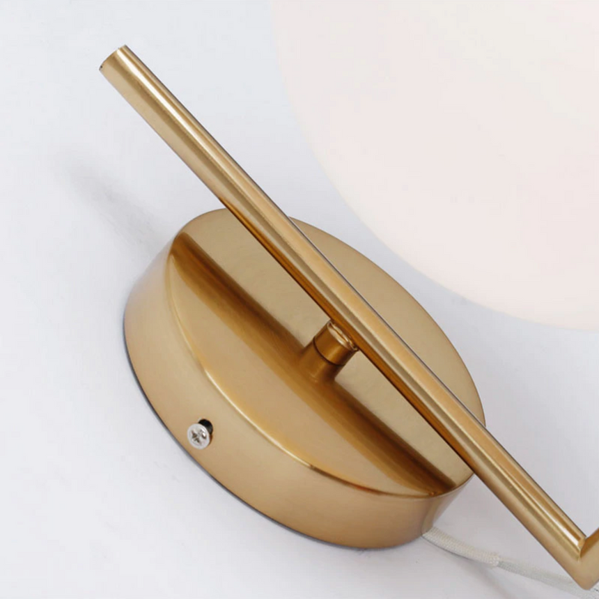 Iron stem detail on brass wall sconce