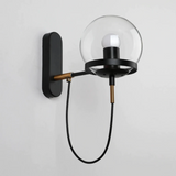 Metal ring detail on glass wall sconce