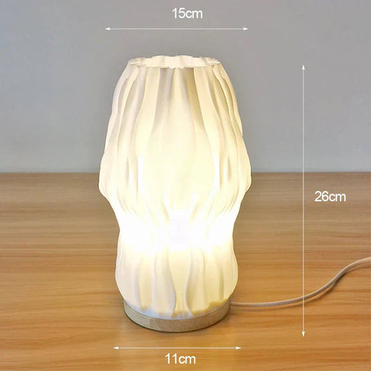 Cream ceramic table lamp with pleated detailing and 3D geometric accents
