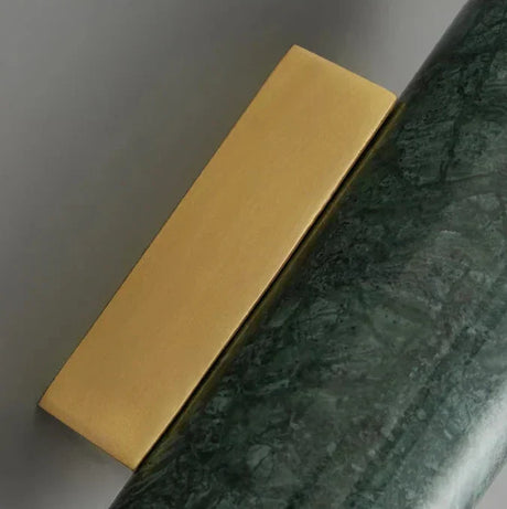 Stone and metal wall sconce with warm glow