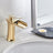 Brass waterfall bathroom faucet installed in a bathroom setting