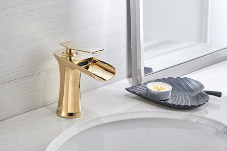 Brass waterfall bathroom faucet installed in a bathroom setting