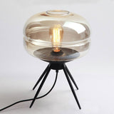 Smoked glass table lamp with modern tripod design