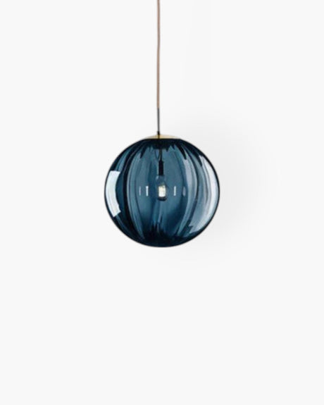 Amber glass pendant light installed above dining table - OpalDwell