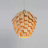 Wood pendant light installed above dining table