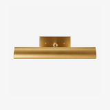 Rolled brass shade under a flat plate, the front edge curving downward