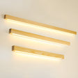 The three lengths shown lit together, pale pine bars stacked on a pale wall